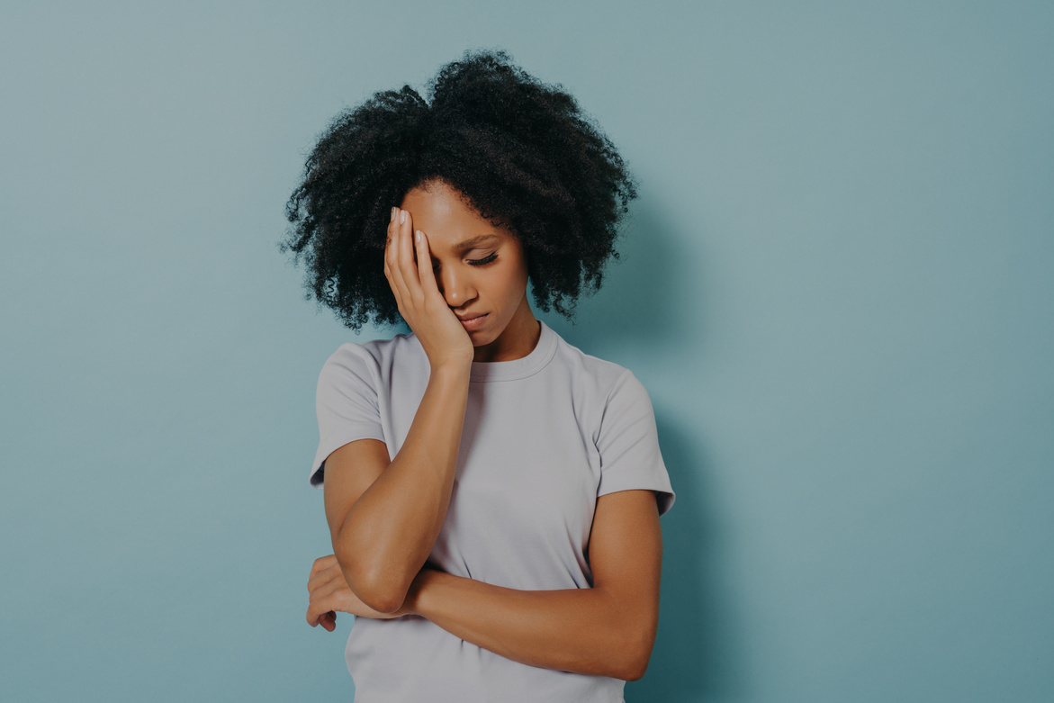 Portrait of Upset African Woman Wearing Casual Clothes Holding Head with Hand, Having Stressful Look